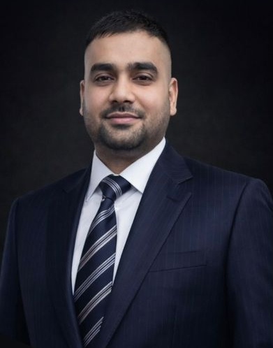 Portrait of Heman Kumar in a navy pinstripe suit